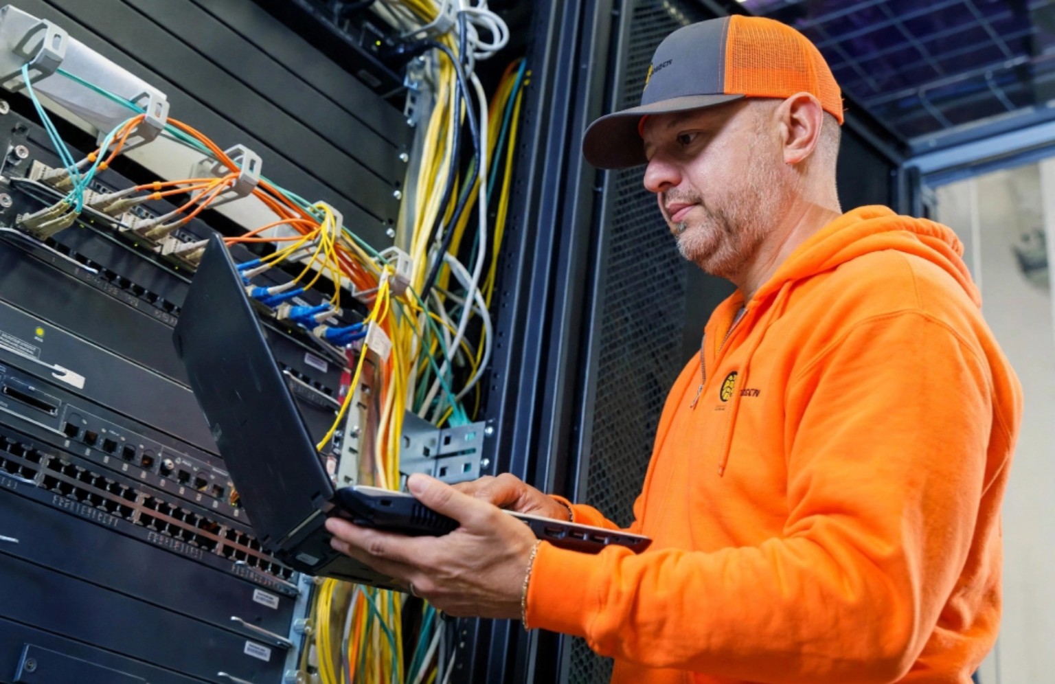 Technician working on network rack